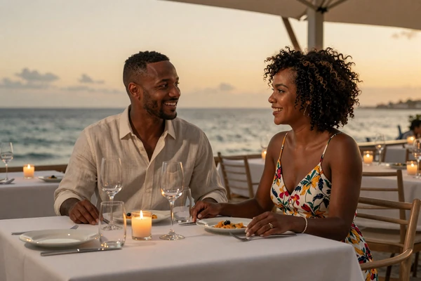 American man and Barbadian woman enjoying a romantic beachside dinner in Barbados