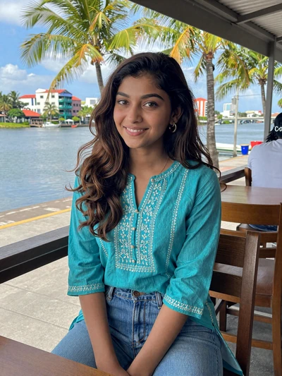 Priya, 23, a charming Hindustani-Surinamese woman at a Paramaribo waterfront cafe
