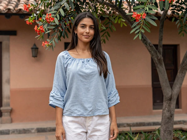 Attractive Paraguayan woman in a traditional courtyard with flowering lapacho tree in Paraguay